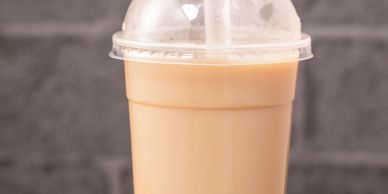 Plastic cup with iced coffee and straw.