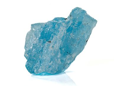 Close-up of a raw blue aquamarine crystal on white background.