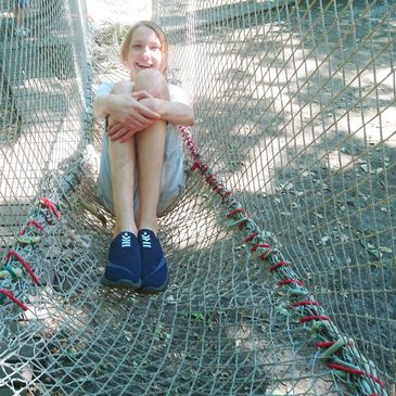 Girl sitting on a treenet