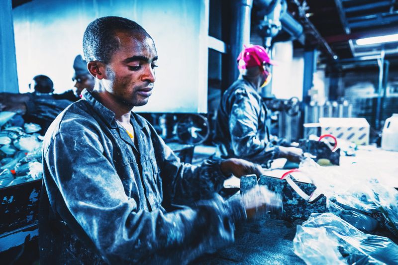 Africa, Industry, Small Business - Busy Factory Workers Working at their Station