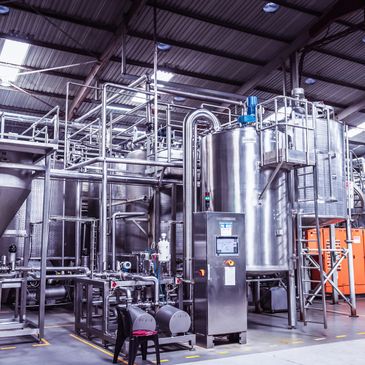 Modern stainless steel industrial machinery in a factory setting.