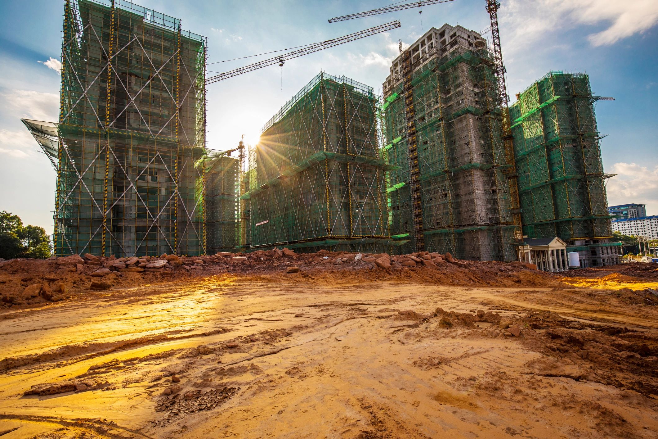 Construction site with multiple buildings covered in scaffolding.