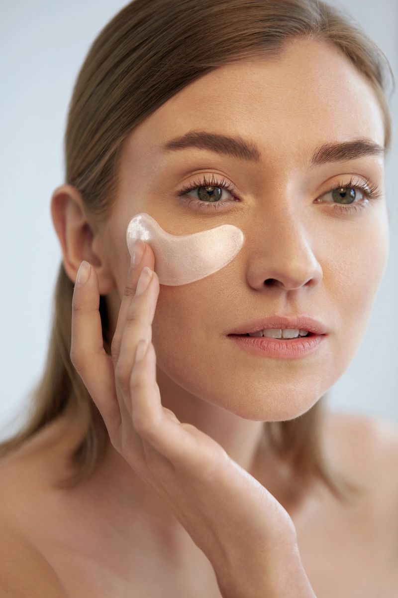 Eye skin care. Woman with beauty patch mask under eyes closeup. Girl using cosmetic collagen pad on face