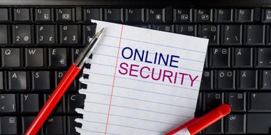 Pen and paper with 'Online Security' on a keyboard background.