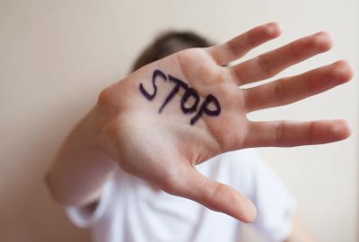 Hand with STOP written on palm.