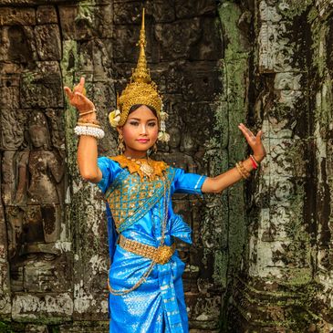 Young dancer in traditional Cambodian costume performing a classical dance.