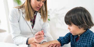 Doctor treating a child's arm injury.