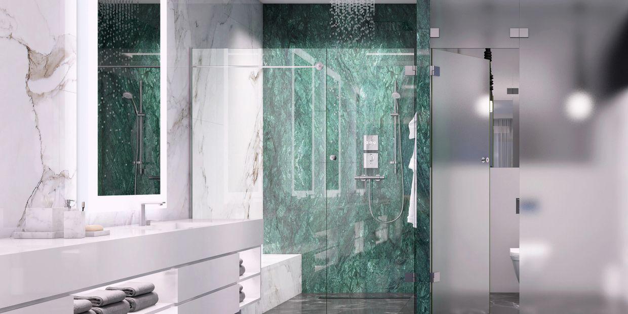 Modern bathroom with green marble shower and sleek white vanity.