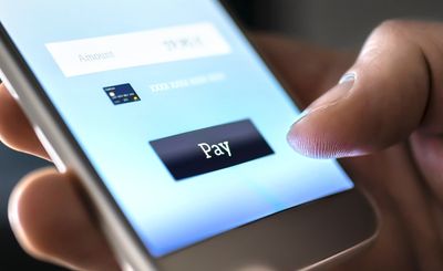 Person about to tap the pay button on a mobile payment app.