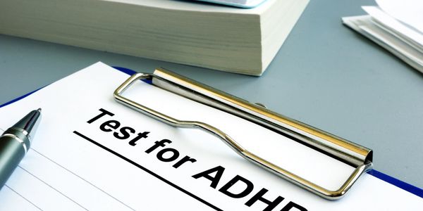 Clipboard with ‘Test for ADHD’ and pen representing ADHD assessment and learning resources.









