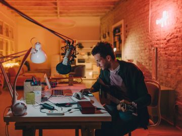 Professional microphone setup with pop filter in recording studio.