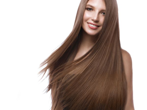 Smiling woman with long, smooth, and shiny brown hair.