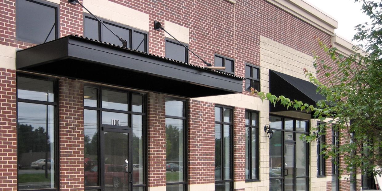 Empty commercial building with brick facade and large windows.