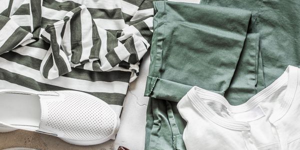 Casual outfit with striped top, green pants, white shoes, sunglasses, and accessories.