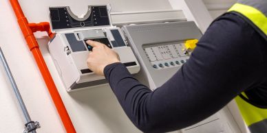 Person inspecting an electrical panel.