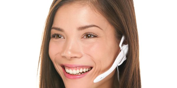 Smiling woman wearing a headset and blue shirt.