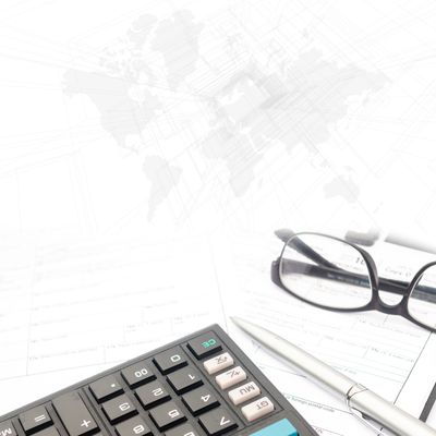 Calculator, pen, and glasses on documents with abstract world map background.