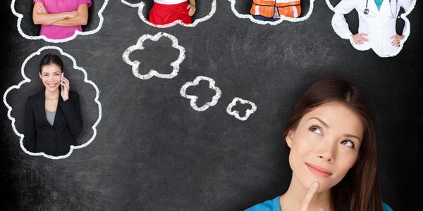 Young woman visualizing different career options on a chalkboard.