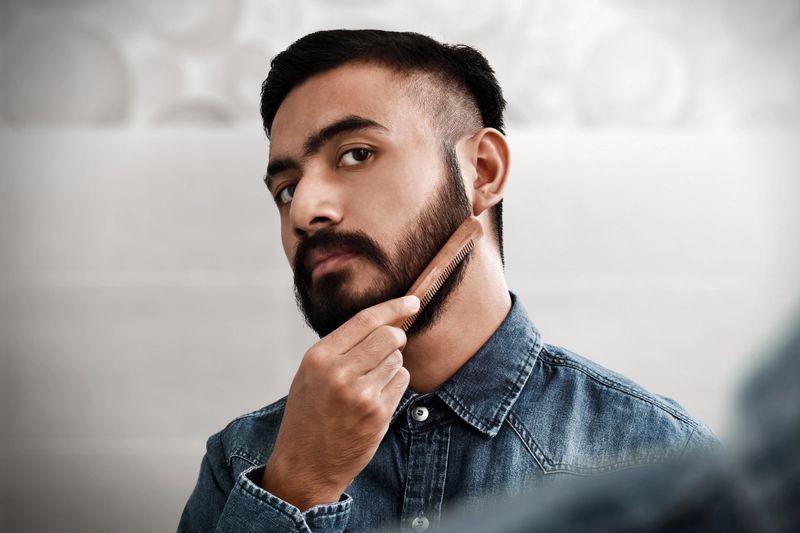 Bearded man comb his beard
