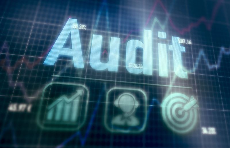 Audit concept on a blue dot matrix computer display.
