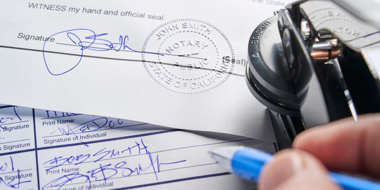 Notary public stamp and signatures on legal documents.