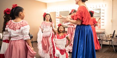 Teacher with a group of young girls with traditional Spanish clothes
