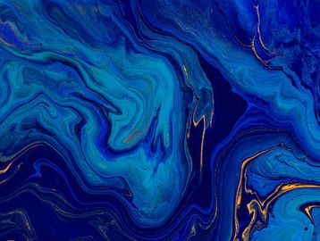Abstract blue and gold swirling paint pattern.