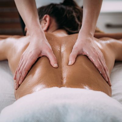 A person relaxing and receiving a massage on their back 