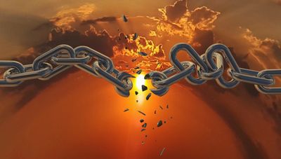 Breaking chain link against a dramatic sunset.