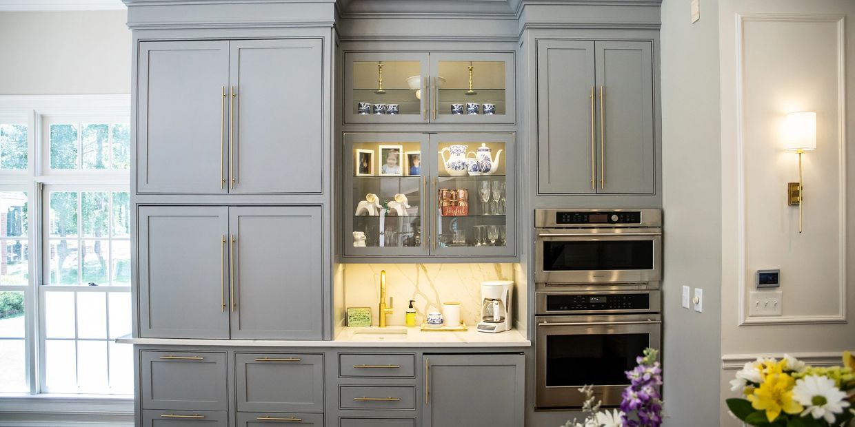 Modern kitchen cabinetry with gray cabinets and stainless steel appliances.