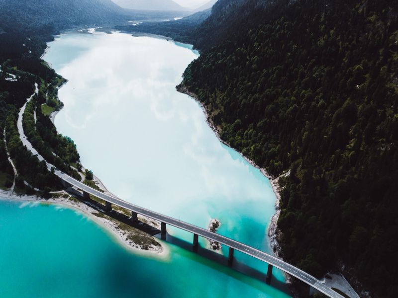 Drone photo of picturesque bridge and road above Sylvenstein lake in Bavaria, Germany