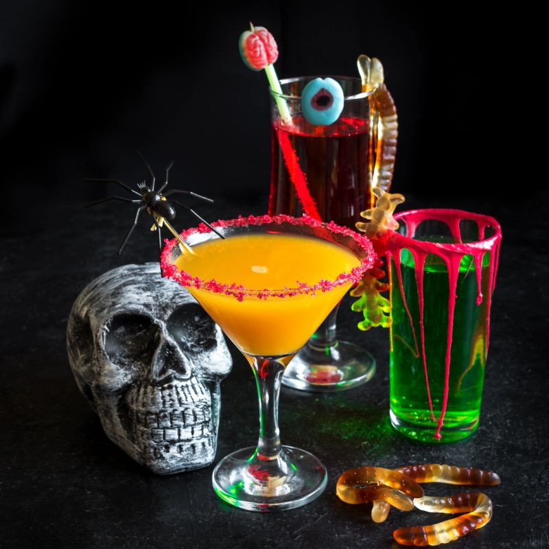 Elegant dark floral cocktail with rose garnish