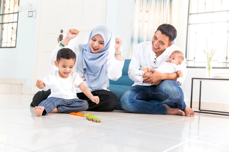 Beautiful young family with spending time in house