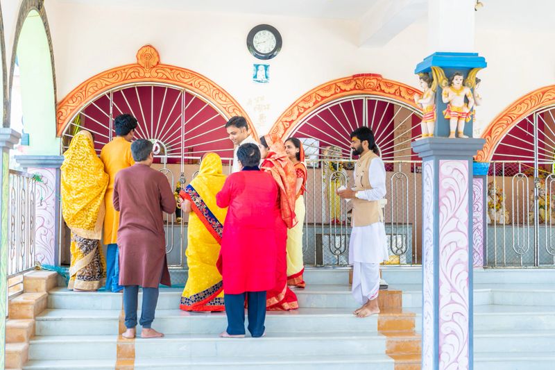 Family, Indian, Hindu, Celebration - A large multi generation family dressed in traditional clothing visiting temple for prayers