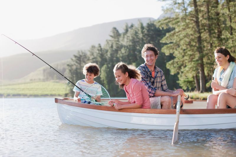 Family fishing in boat on lake