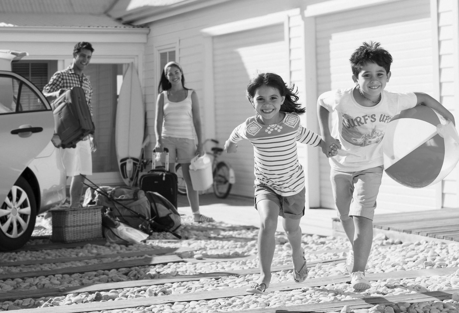 Stack of books next to pencils in a holder and a camera.