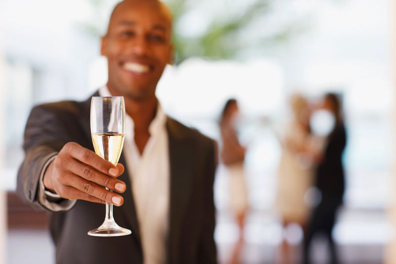 Close up of man holding champagne flute