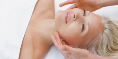 Woman receiving a facial massage.