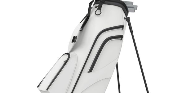 White golf bag with black accents and stand.