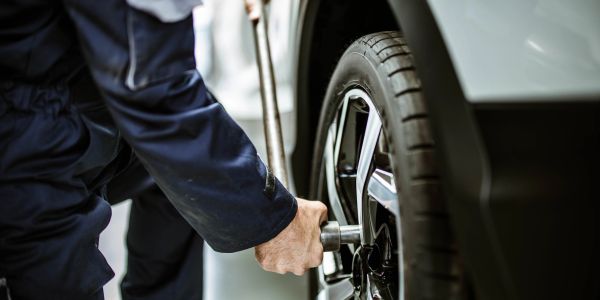 Mechanic fixing a car tire.