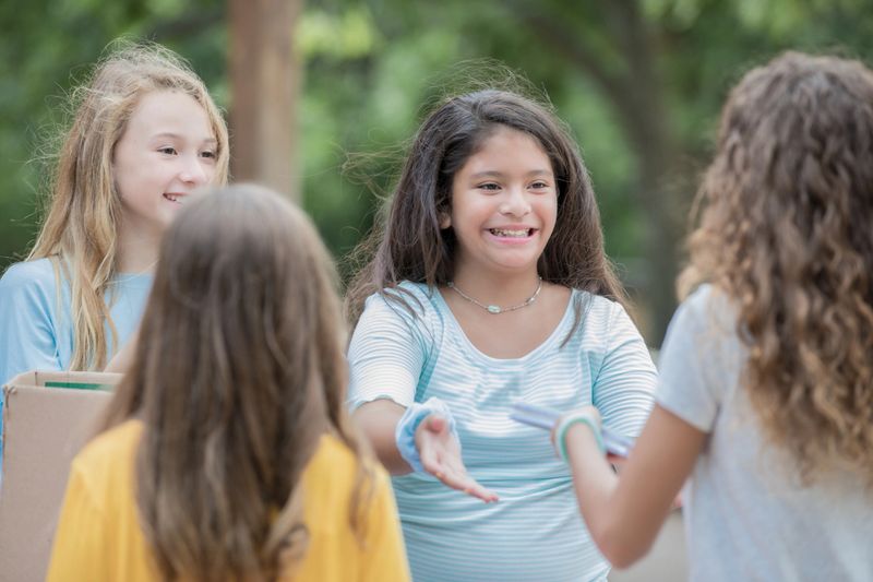 Diverse group of children collecting donated school supplies at elementary school