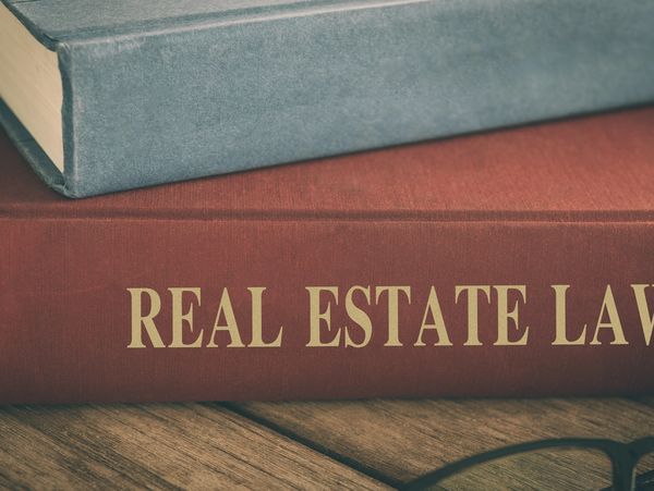Real Estate Law book on a desk.