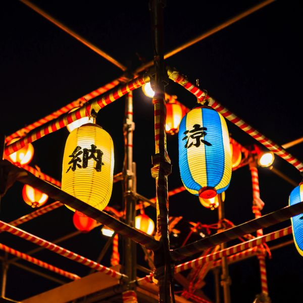Colorful Japanese lanterns glowing at night.