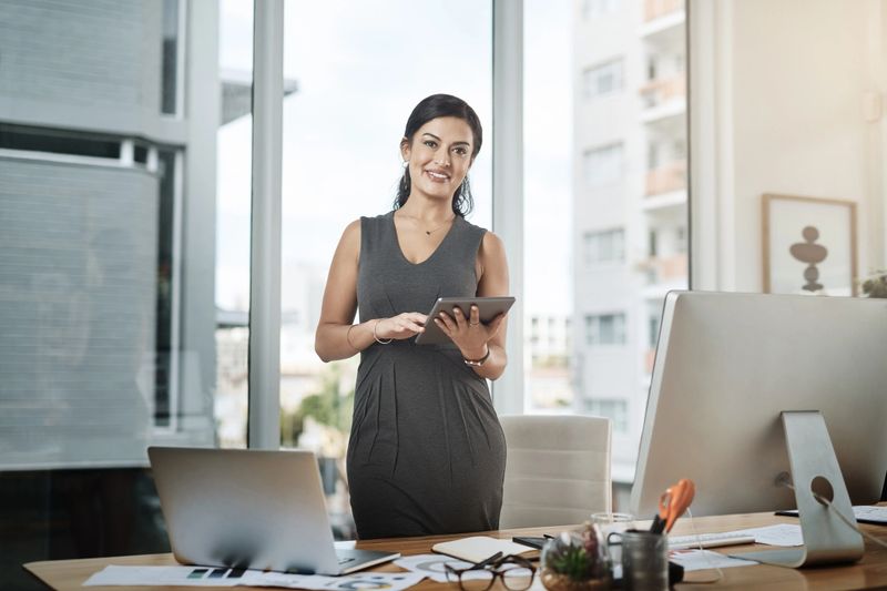 Portrait of a young businesswoman using a digital tablet in an office
