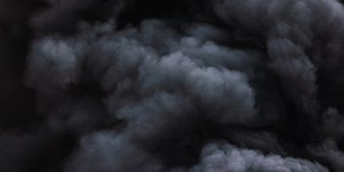 Thick black smoke with intense red flames rising from a fire.