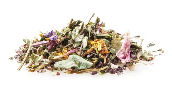 A pile of dried mixed herbs and flowers on a white background.