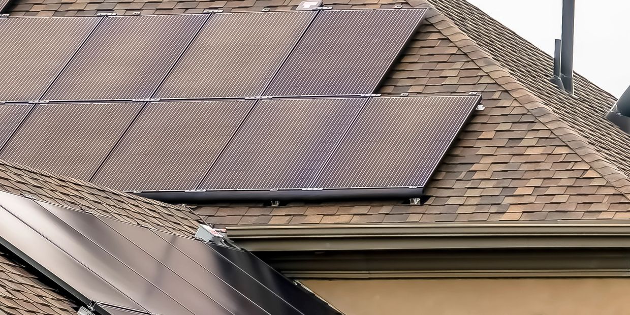 Solar panels installed on a shingled roof for renewable energy.