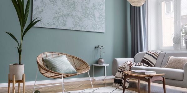 Cozy living room with pastel blue walls and minimalistic furniture.