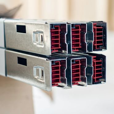 Close-up of metallic computer connectors with red interiors.