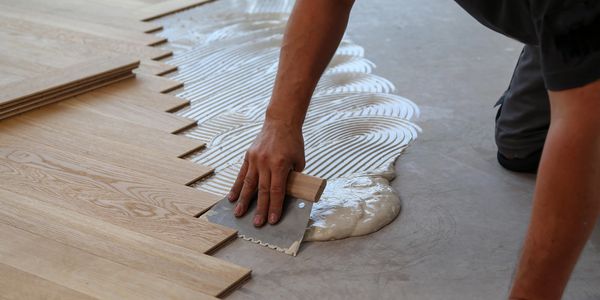 Solid Oak Herringbone Batons being fully bonded to the subfloor